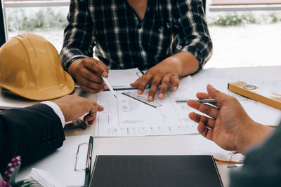 Midsection of man working on table