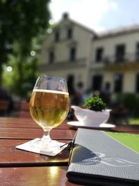 Close-up of wine glass on table against building