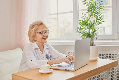 Young businesswoman using laptop at office