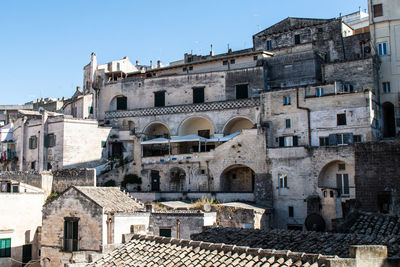 Buildings in city against clear sky