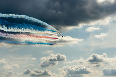 Low angle view of airshow against sky