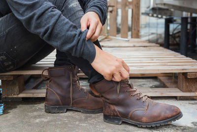 Low section of man sitting on bench