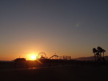 Pacific park silhouette at sunset, santa monica pier, california, usa