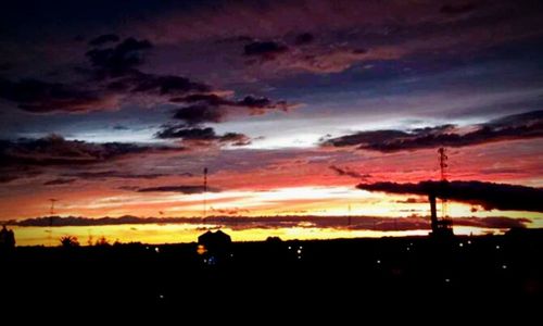 Silhouette of landscape against cloudy sky