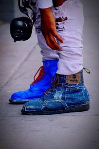 Low section of man standing on street