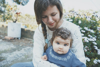 Portrait of cute mother and daughter outdoors