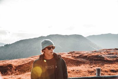 Man standing on mountain against sky