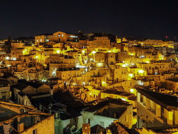 High angle view of illuminated town against sky at night