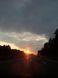 Road against cloudy sky at sunset