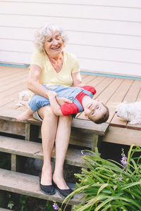 Portrait of smiling woman sitting outdoors