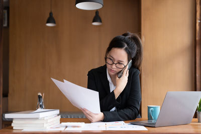 Businesswoman using laptop at office