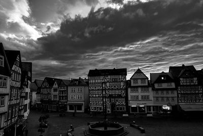 Buildings against cloudy sky