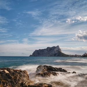 Scenic view of rocks on beach against sky