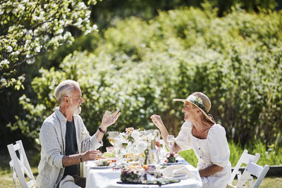 High angle view of people sitting on table