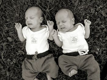 High angle view of baby twins on grass