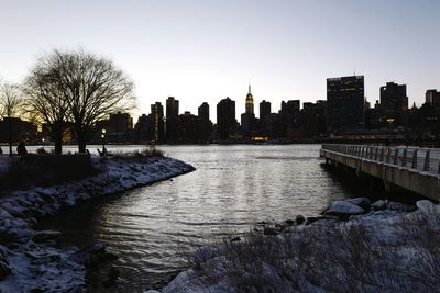 Scenic view of cityscape against clear sky during sunset