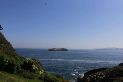 Scenic view of sea against clear blue sky