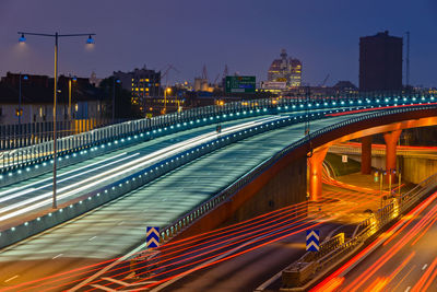 High angle view of light trails on bridge at night