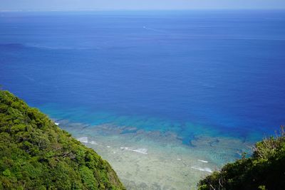 High angle view of sea against blue sky