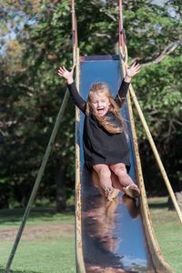 Happy girl on swing at playground