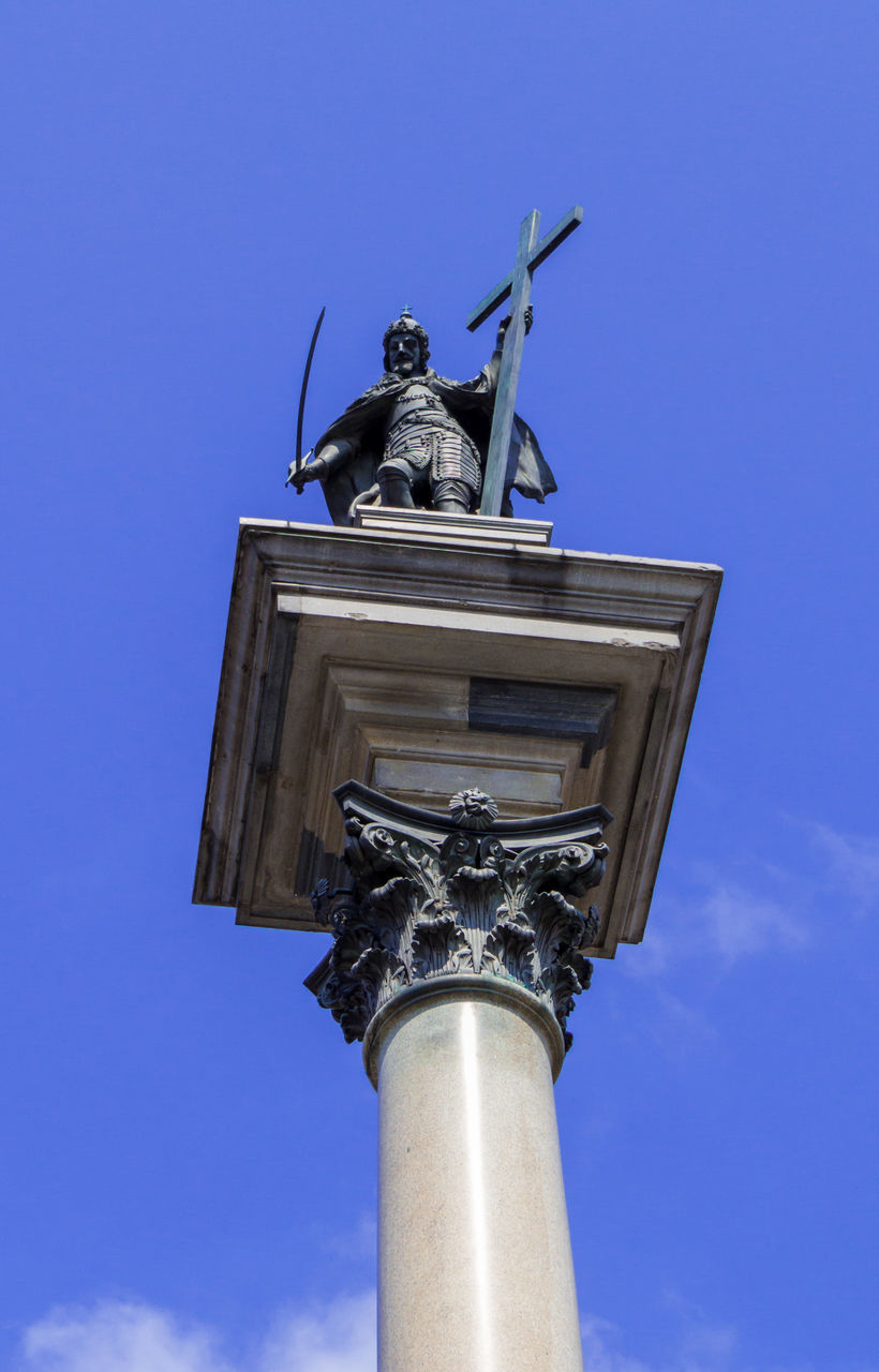 sky, architecture, blue, low angle view, sculpture, statue, built structure, nature, no people, day, street light, human representation, representation, history, travel destinations, the past, clear sky, building exterior, cloud, outdoors, monument, architectural column, city, landmark, memorial