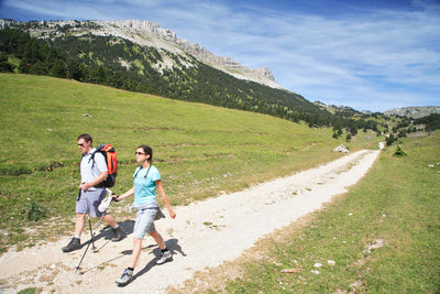 Rear view of people walking on road
