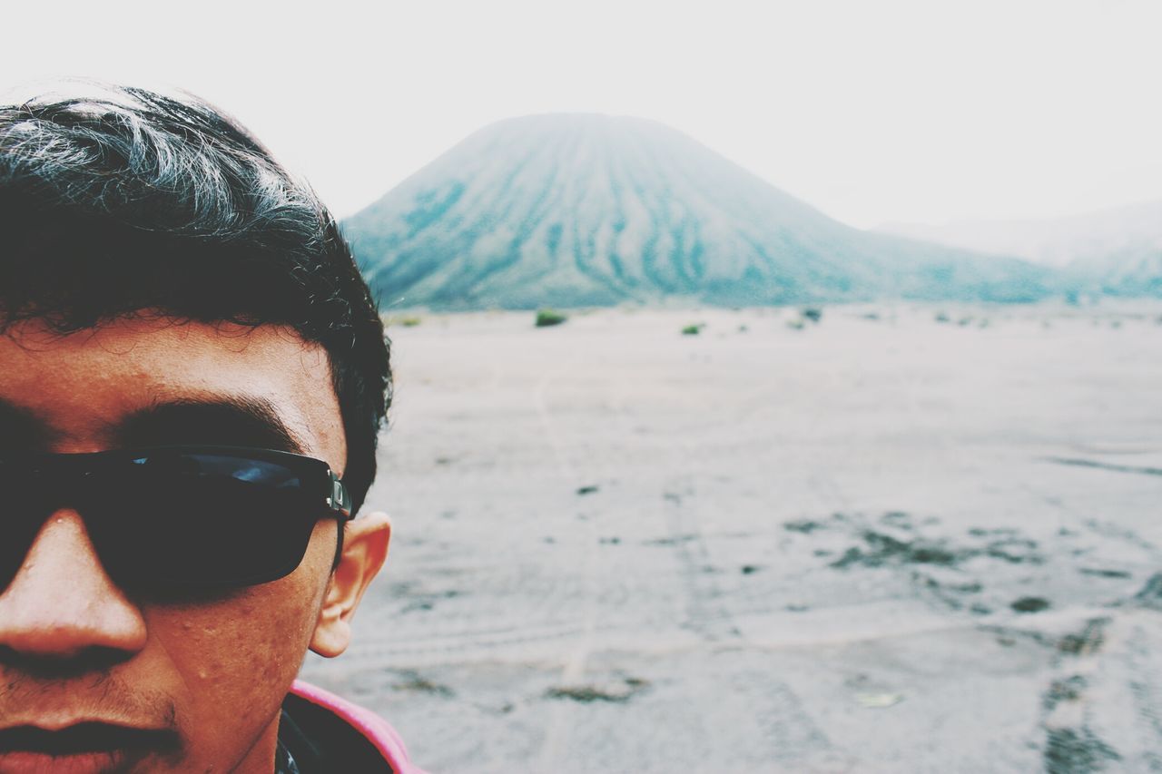 lifestyles, headshot, leisure activity, sunglasses, young adult, mountain, close-up, young men, winter, clear sky, person, focus on foreground, looking at camera, front view, nature, men, portrait, head and shoulders