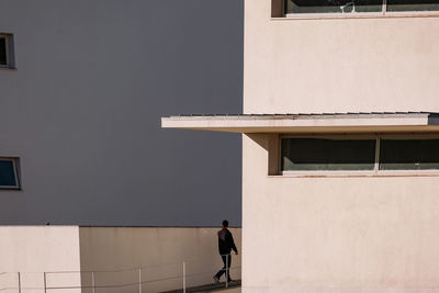 Man walking by building