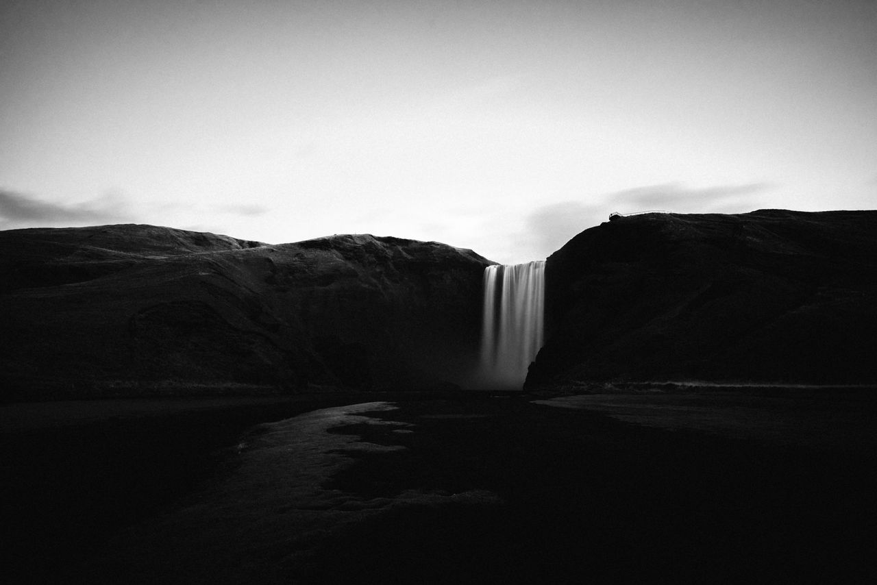 sky, scenics - nature, no people, beauty in nature, environment, water, nature, long exposure, waterfall, motion, day, mountain, rock, tranquil scene, flowing, flowing water, outdoors, tranquility, land, power in nature