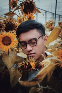 Young man with sunflowers