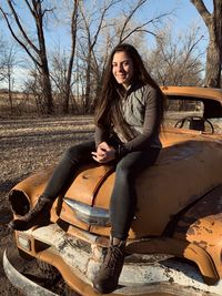 Portrait of beautiful woman sitting in car