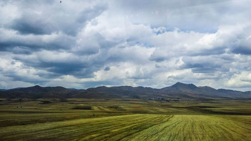 Scenic view of agricultural field against sky