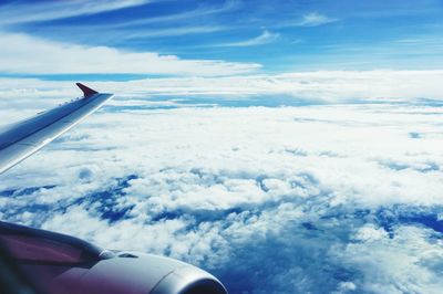 Aerial view of cloudscape over airplane wing