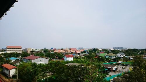 Houses in town against clear sky