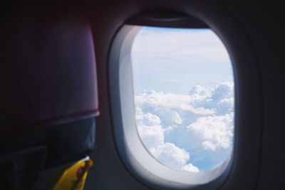 View of cloudy sky seen through airplane window