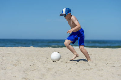 Man playing with ball on beach