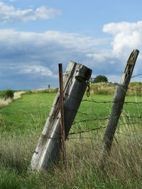 Metallic structure on field against sky