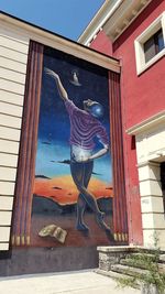 Man standing by window of building