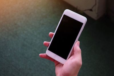 Close-up of person holding mobile phone