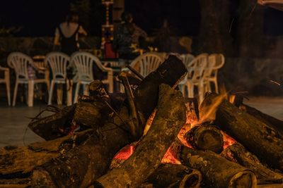 Close-up of fire on log at night