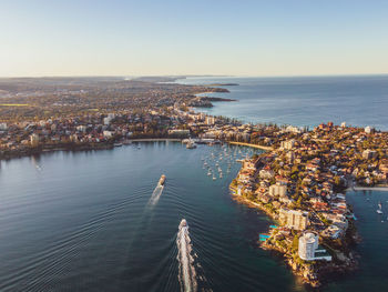 Drone view of two ferries arriving at manly wharf. manly is a beach-side suburb of sydney, australia