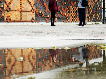 Low section of people walking on street during rainy season