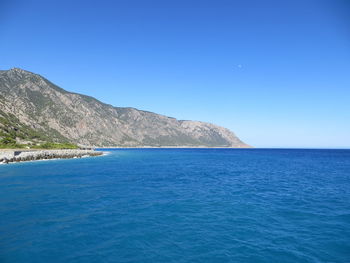 Scenic view of sea against clear blue sky