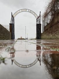 Reflection of bridge in puddle