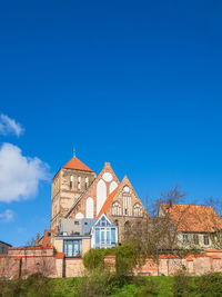 Low angle view of historic building against blue sky