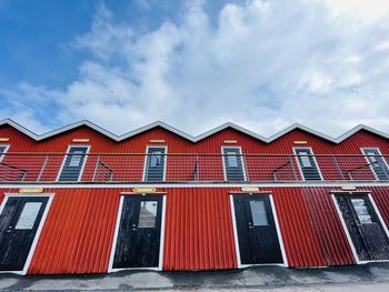A view of red wooden houses on donso archipelago island .