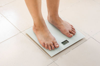 Low section of woman standing on floor