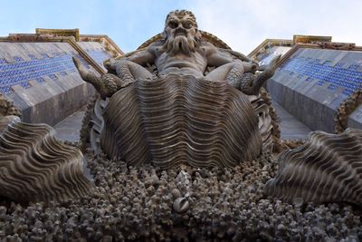 Low angle view of statues against sky