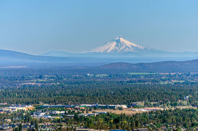 Scenic view of landscape with mt hood in background against clear sky