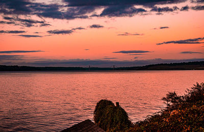 Scenic view of lake against romantic sky at sunset